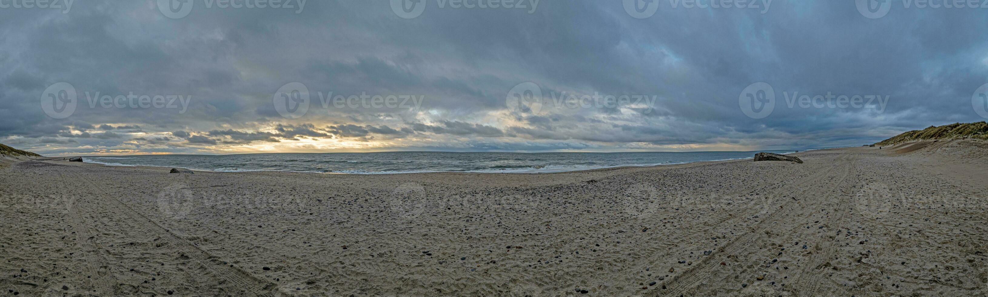 Panoramic picture over a beach in Jutland in rough weather photo