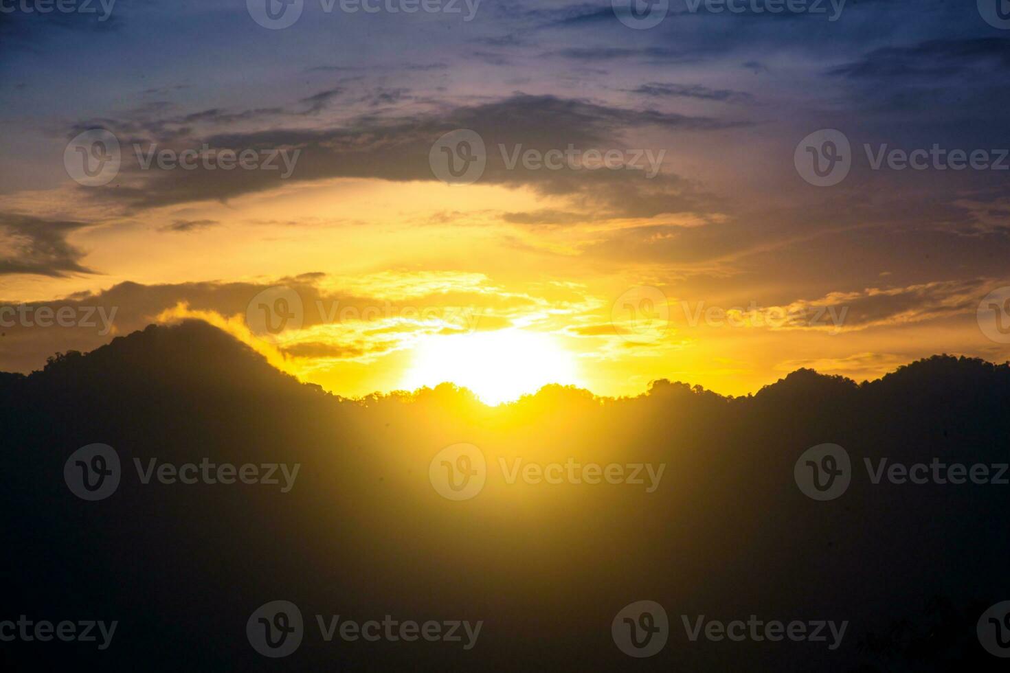 Mountain silhouette against colorful sky with sunset photo