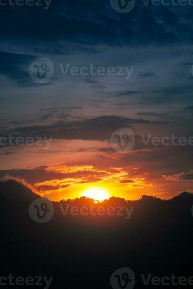 Beautiful sunset sky with mountain silhouette photo