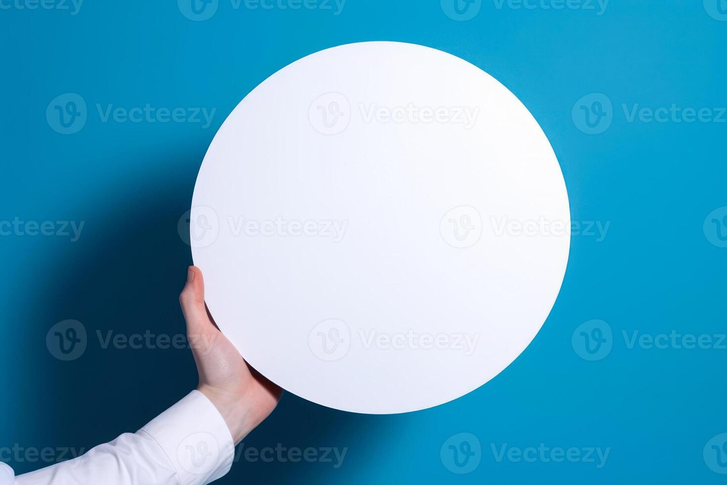 circle empty white mockup in hand on blue background photo