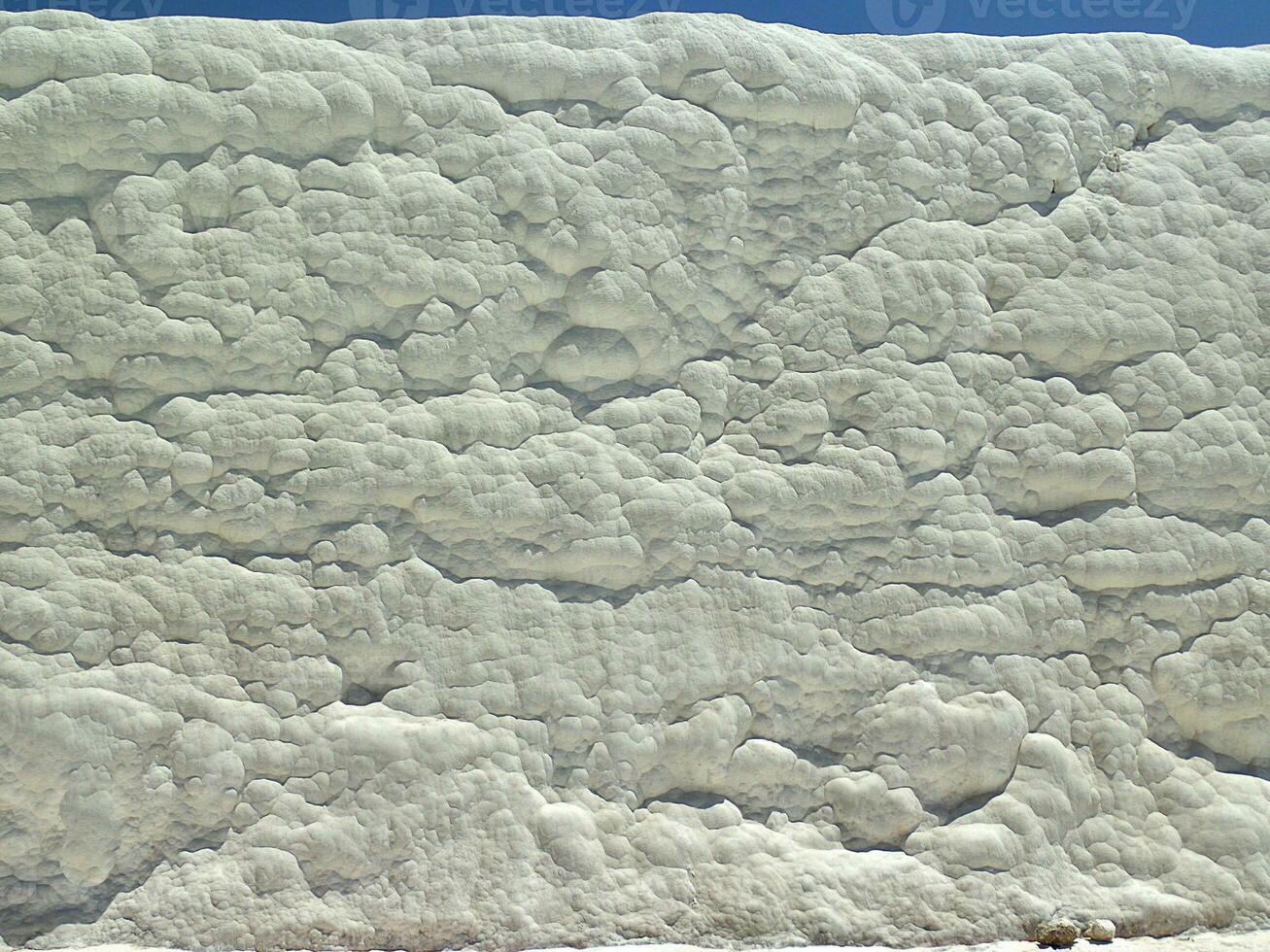 natural limestone background with traces of water from Pamukkale in Turkey in close-up photo