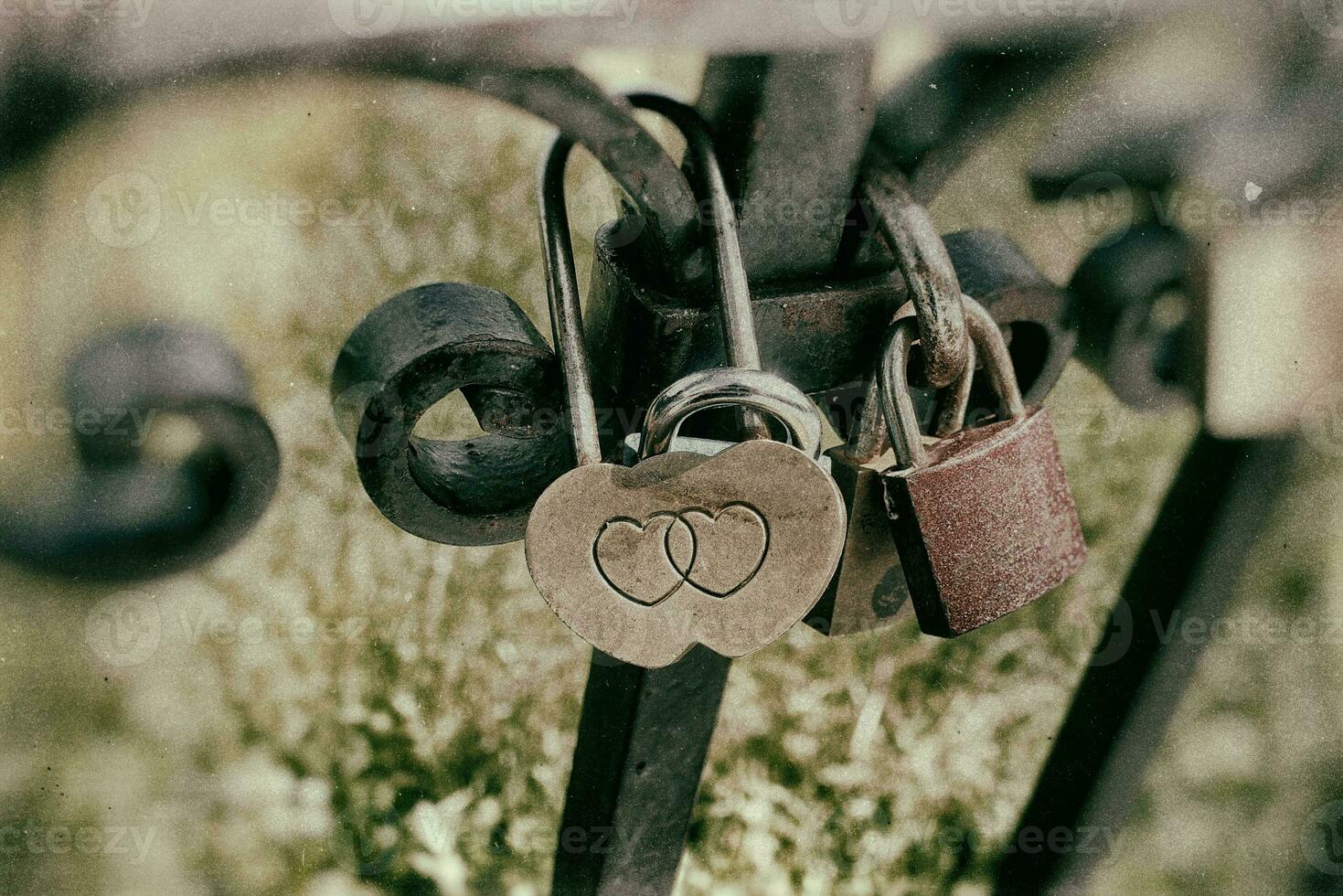 vintage padlocks pinned to the fence as a symbol of love with the names of the lovers inscribed photo