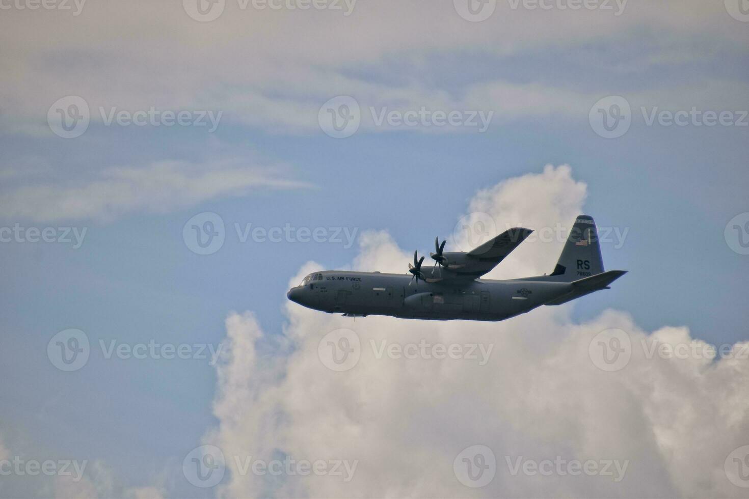 flying combat aircraft against the blue sky with clouds on a sunny day photo