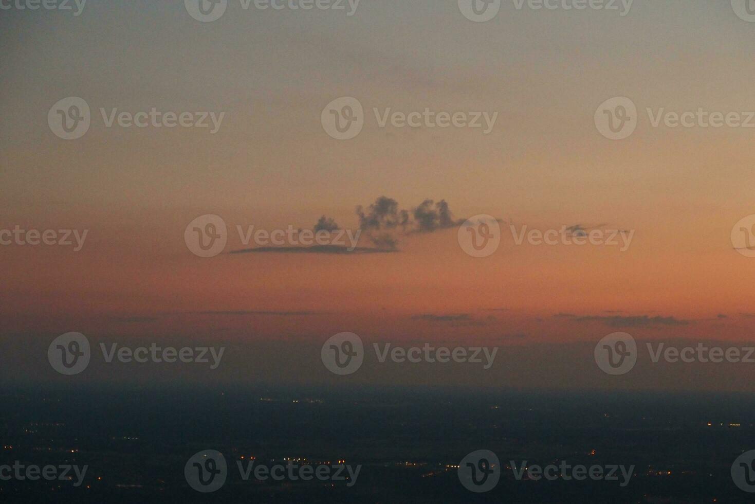 mysterious sunset with clouds from the airplane window with photo