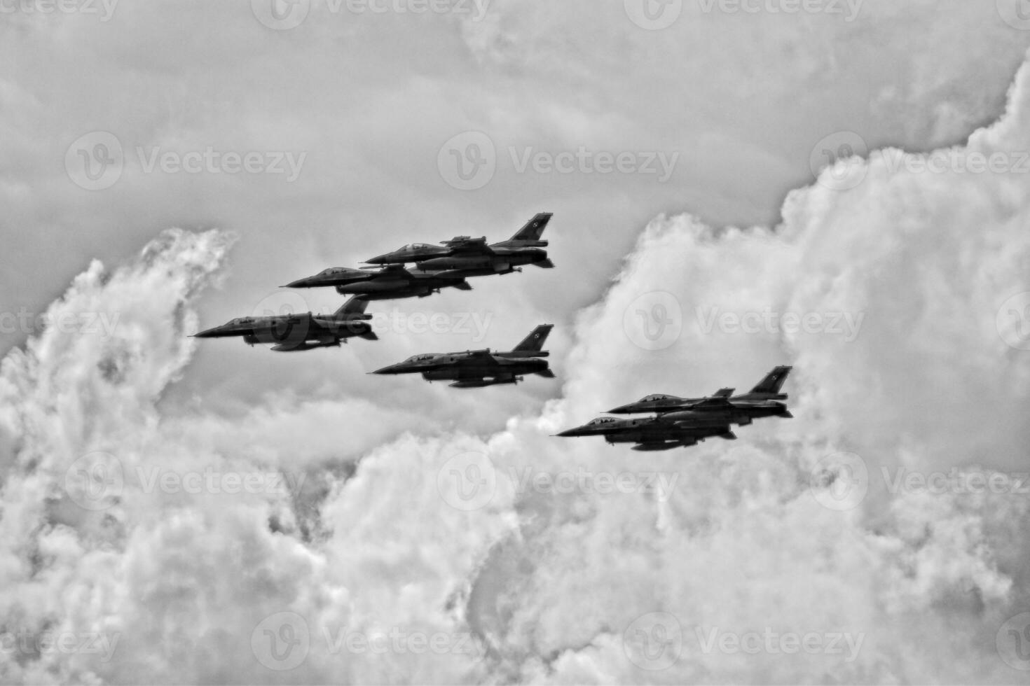 flying combat aircraft against the blue sky with clouds on a sunny day photo