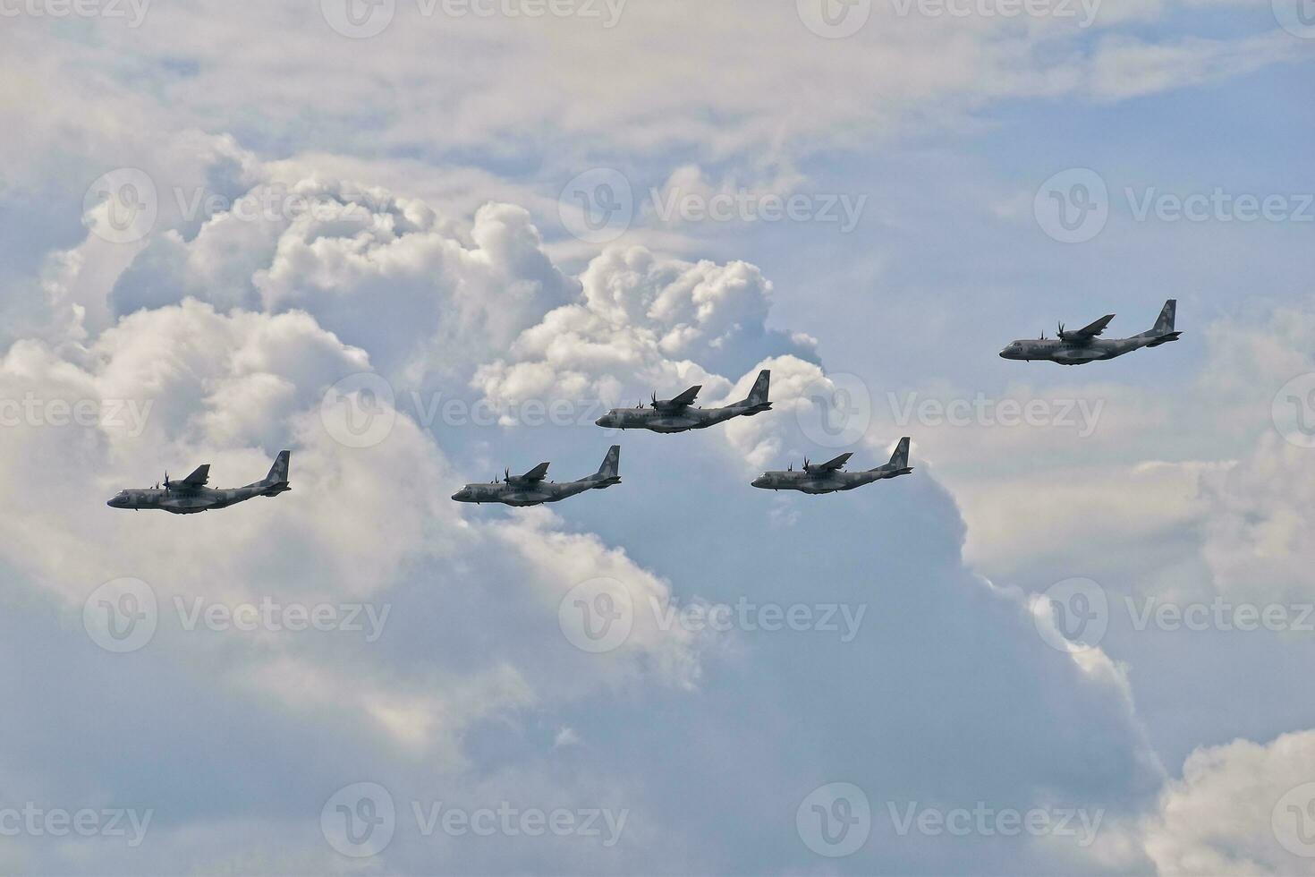 flying combat aircraft against the blue sky with clouds on a sunny day photo