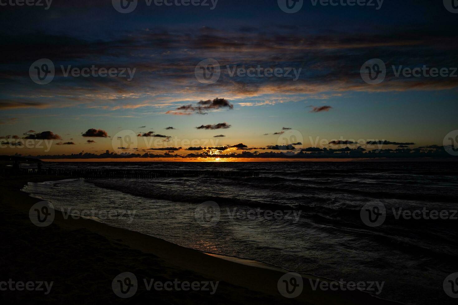 picturesque calm sunset with colorful clouds on the shores of the Baltic Sea in Poland photo