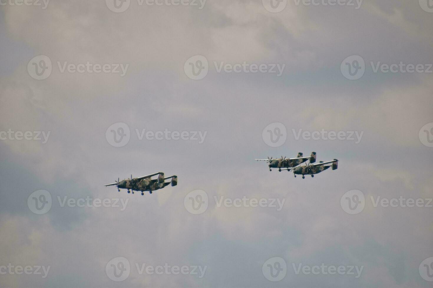 flying combat aircraft against the blue sky with clouds on a sunny day photo