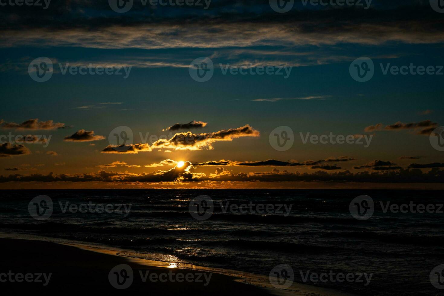 picturesque calm sunset with colorful clouds on the shores of the Baltic Sea in Poland photo