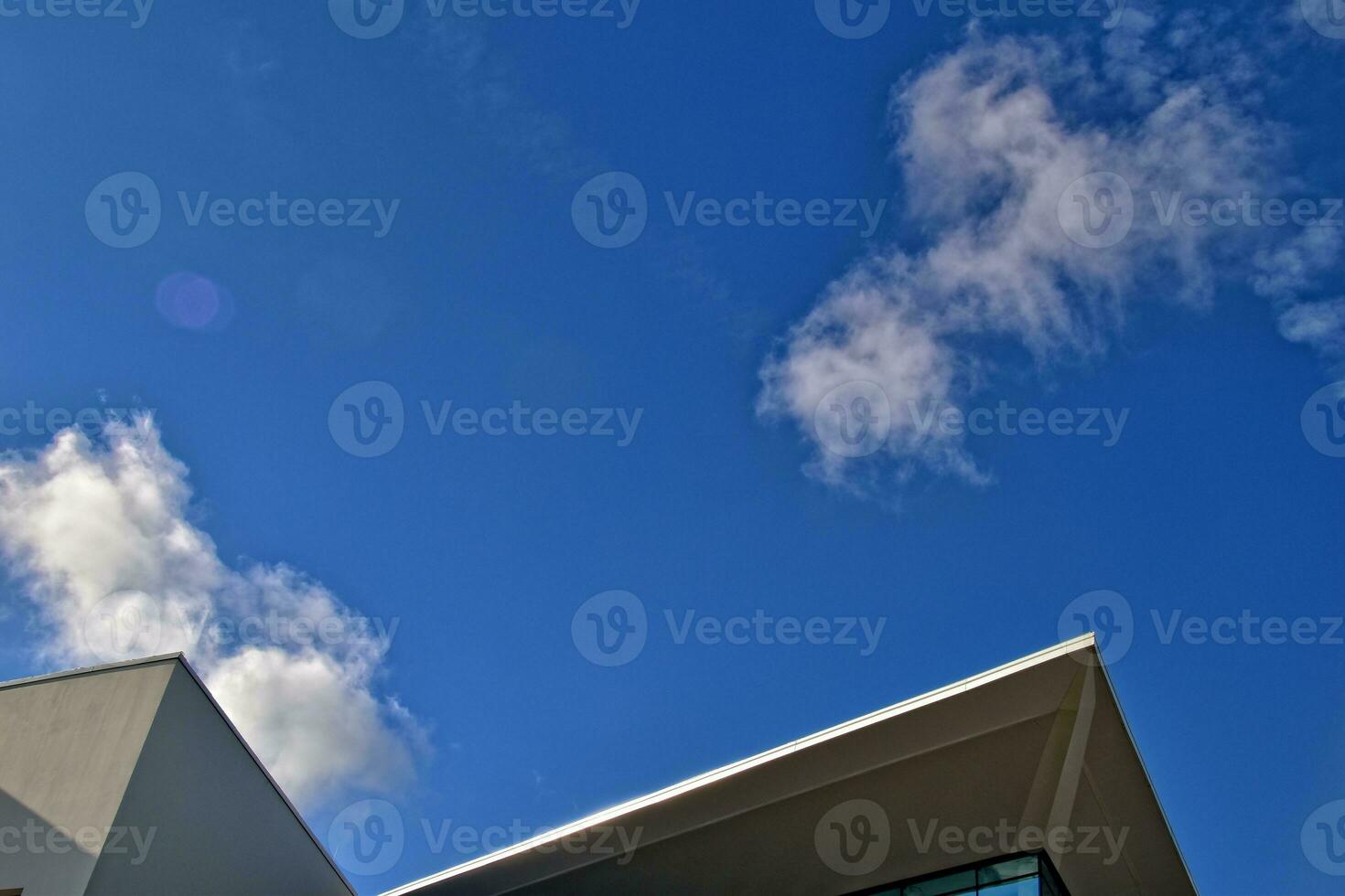 modern original fragments of architecture against the blue sky creating an interesting background photo