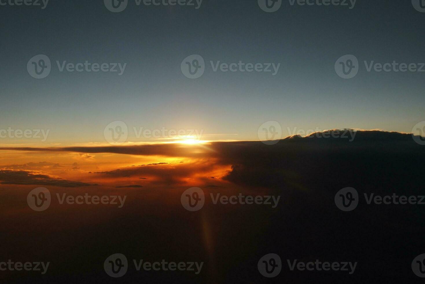 mysterious sunset with clouds from the airplane window with photo