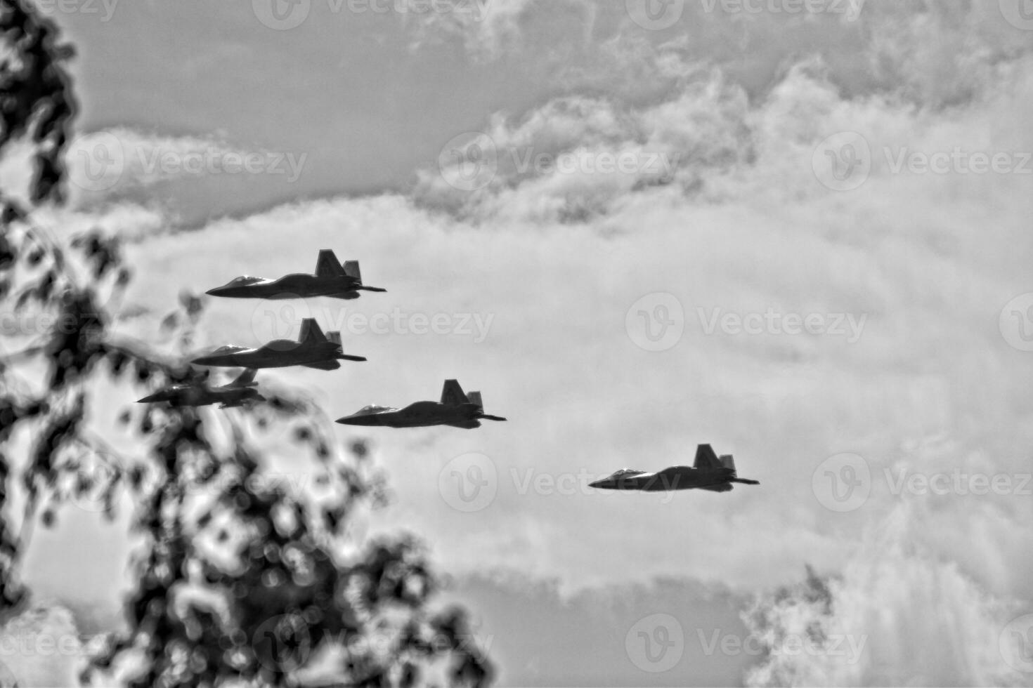 flying combat aircraft against the blue sky with clouds on a sunny day photo