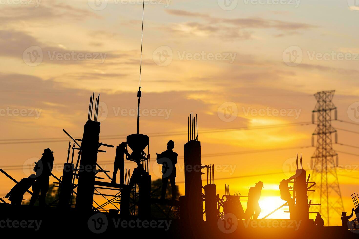 Silhouette of Engineer and worker team checking project at building site background, construction site with sunset in evening time background photo