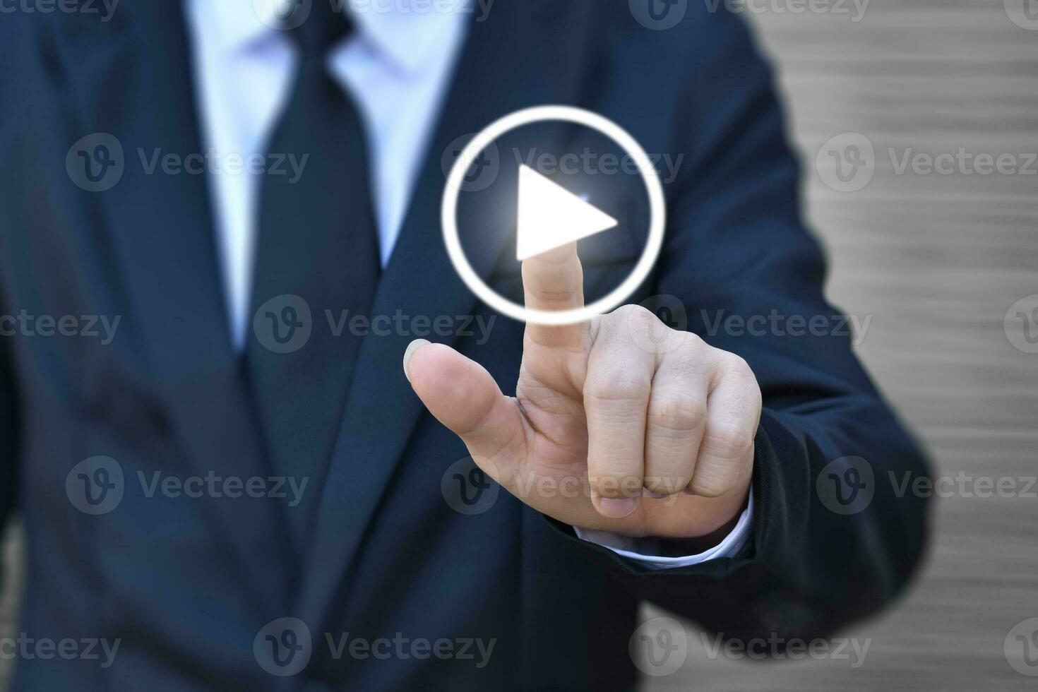Businessman pressing play button to start. Idea for business, technology and presentation. photo