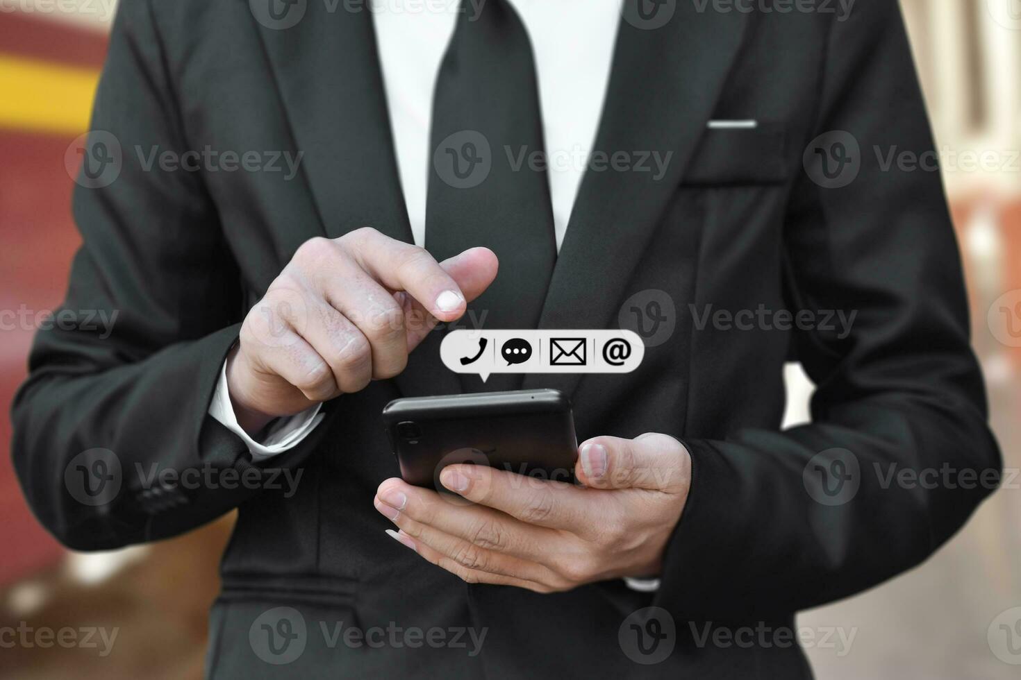 Businessman hand holding smartphone with icon mobile phone, and email address. Concept of customer service call center contact. photo