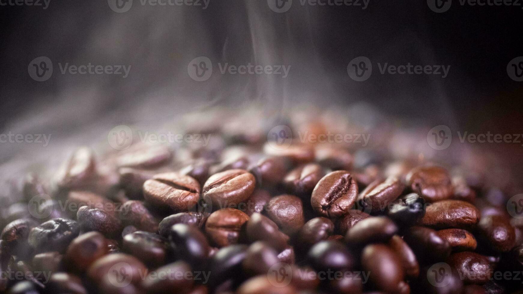 Coffee beans roasting with smoke,  selective focus, and soft focus. photo