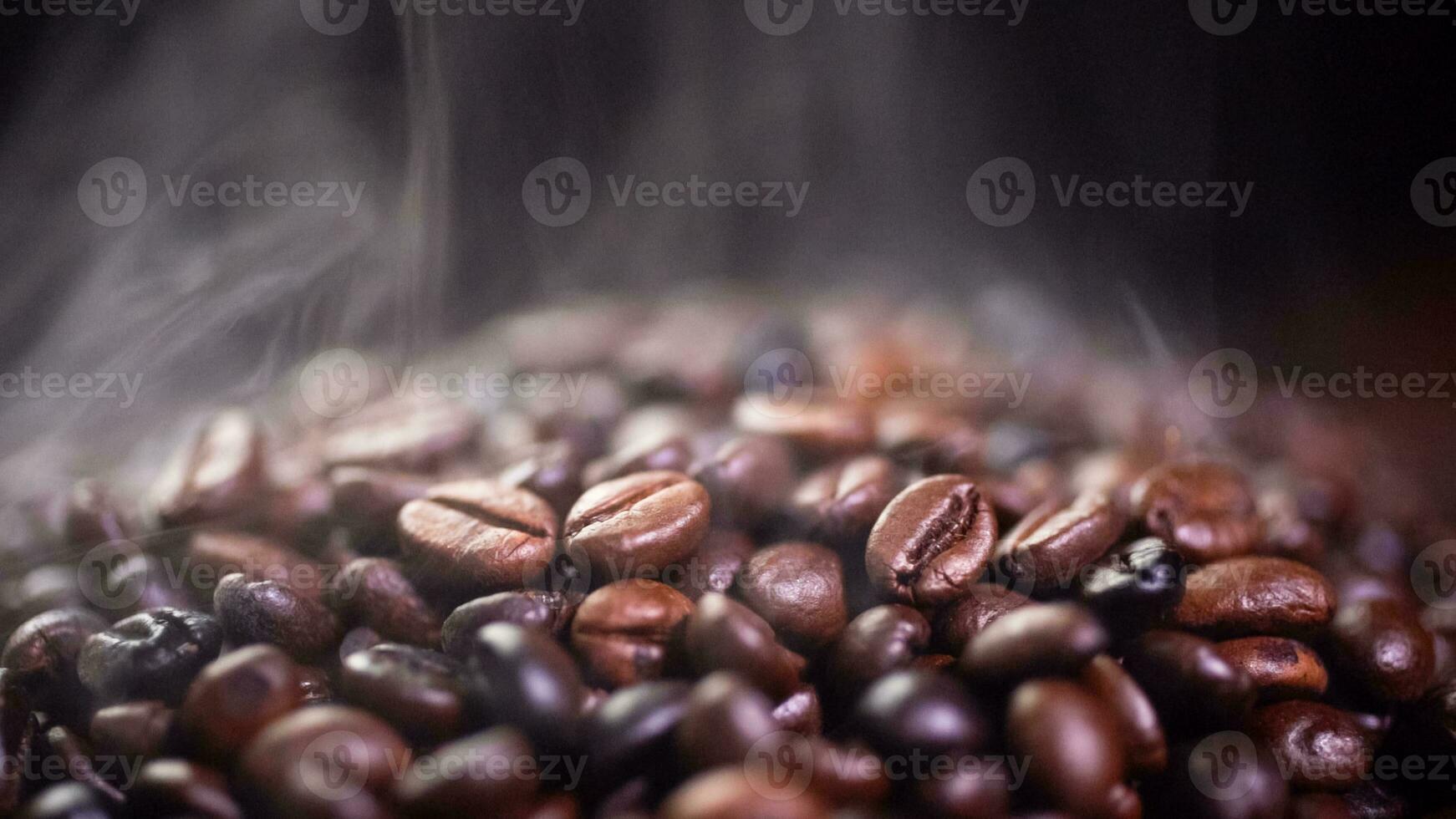 Coffee beans roasting with smoke,  selective focus, and soft focus. photo