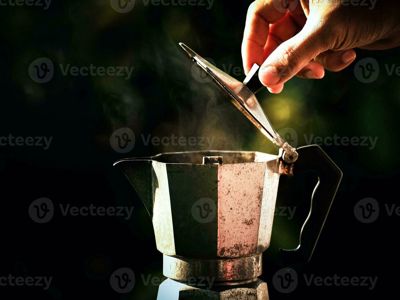 Moka pot coffee maker, making hot drinks in nature camp Traveling, relaxing outdoors, camping, lifestyle, morning picnic.selective focus, and soft focus. photo