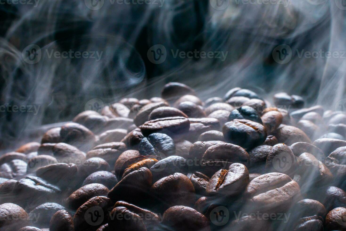 Coffee beans roasting with smoke,  selective focus, and soft focus. photo
