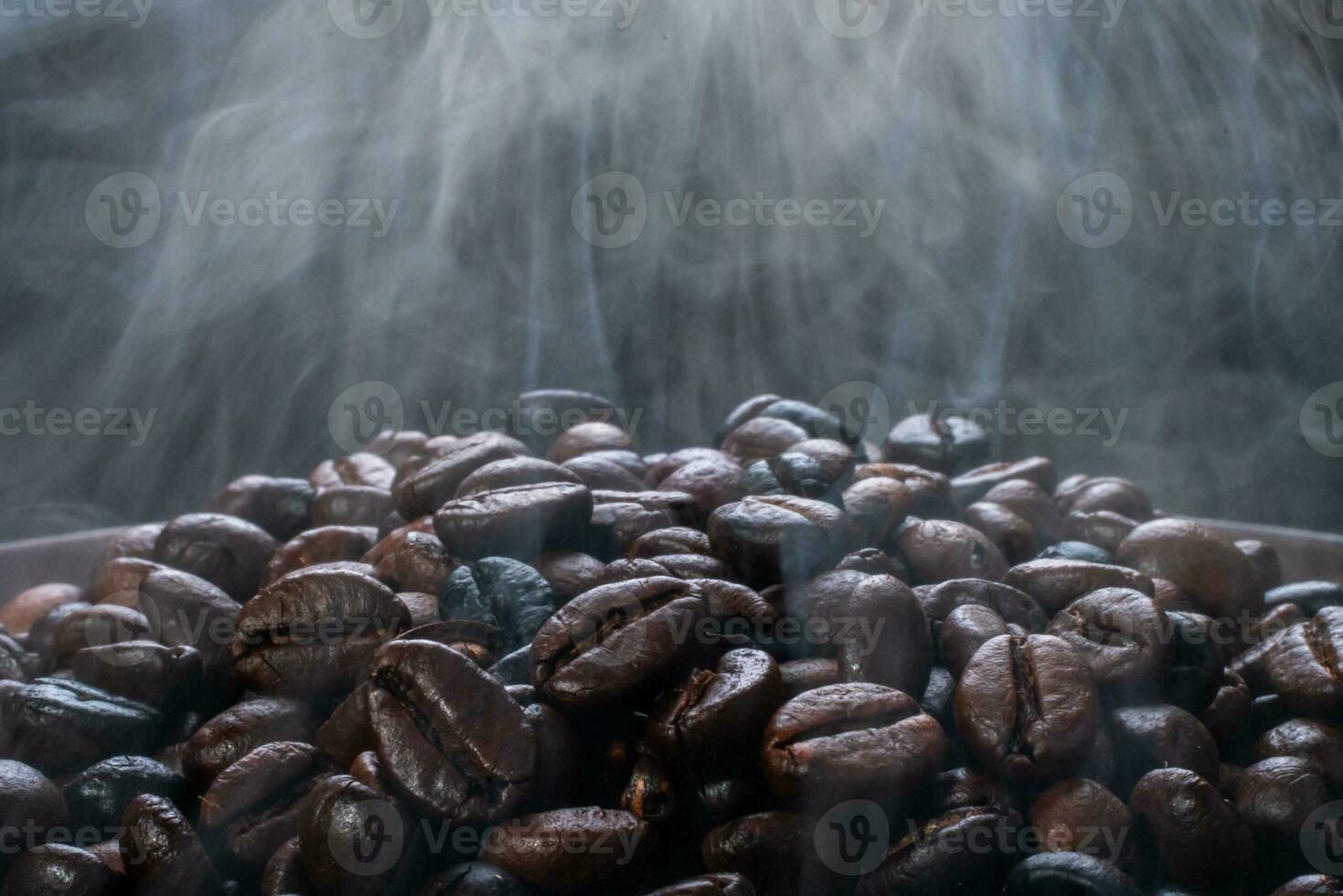 Coffee beans roasting with smoke,  selective focus, and soft focus. photo