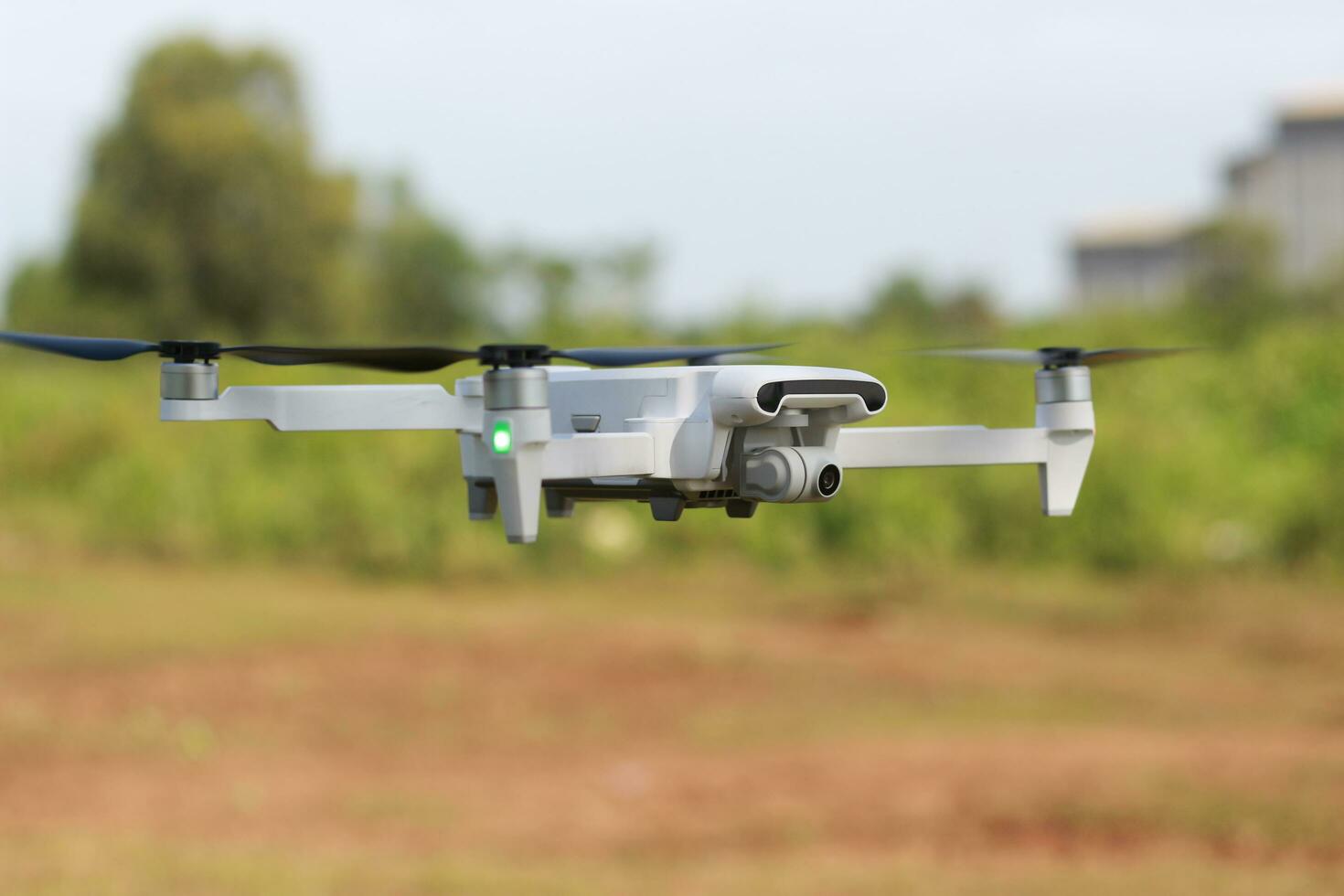 Bogor, Indonesia - 2022. a photo of a drone flying with a blurry propeller against a green open space background. technology photo concept.