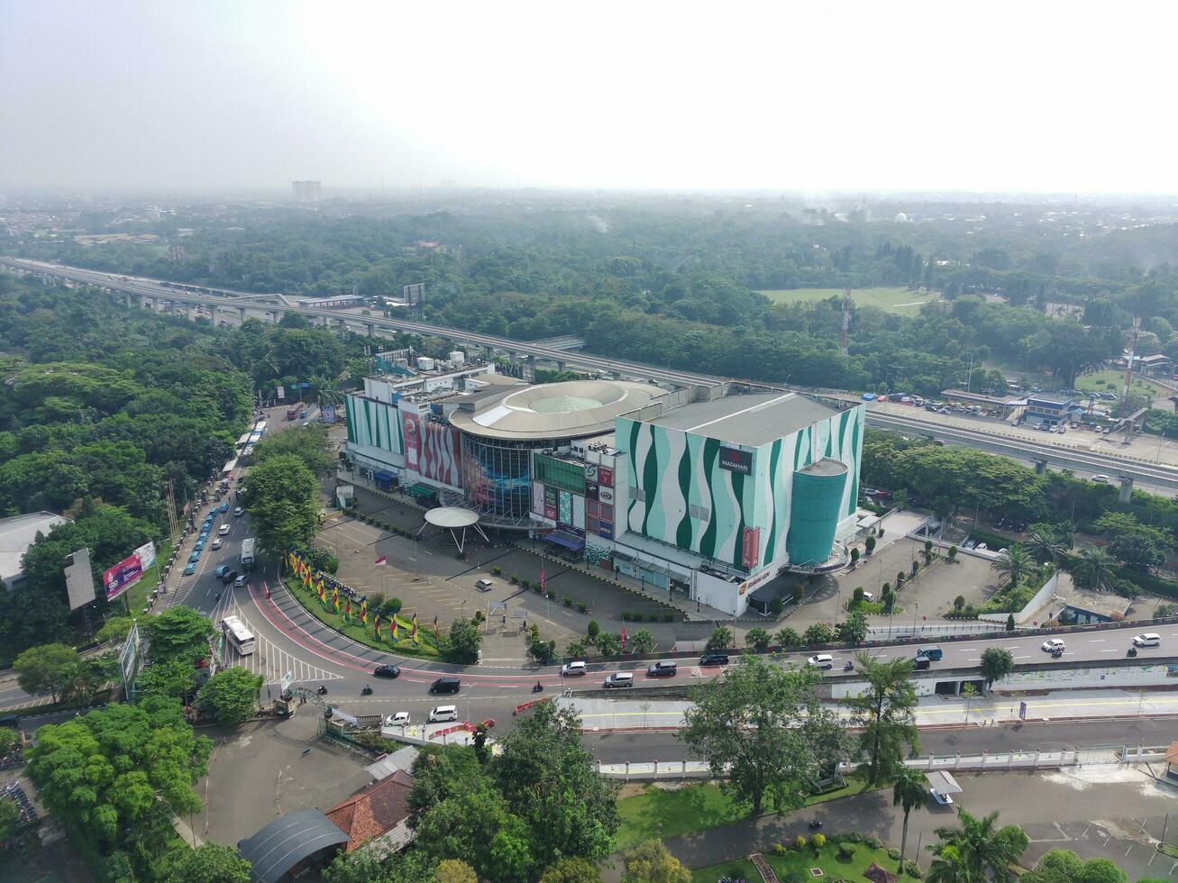 Bogor, Indonesia - 2022. 4K footage aerial view of a shopping mall at a crossroads. photo