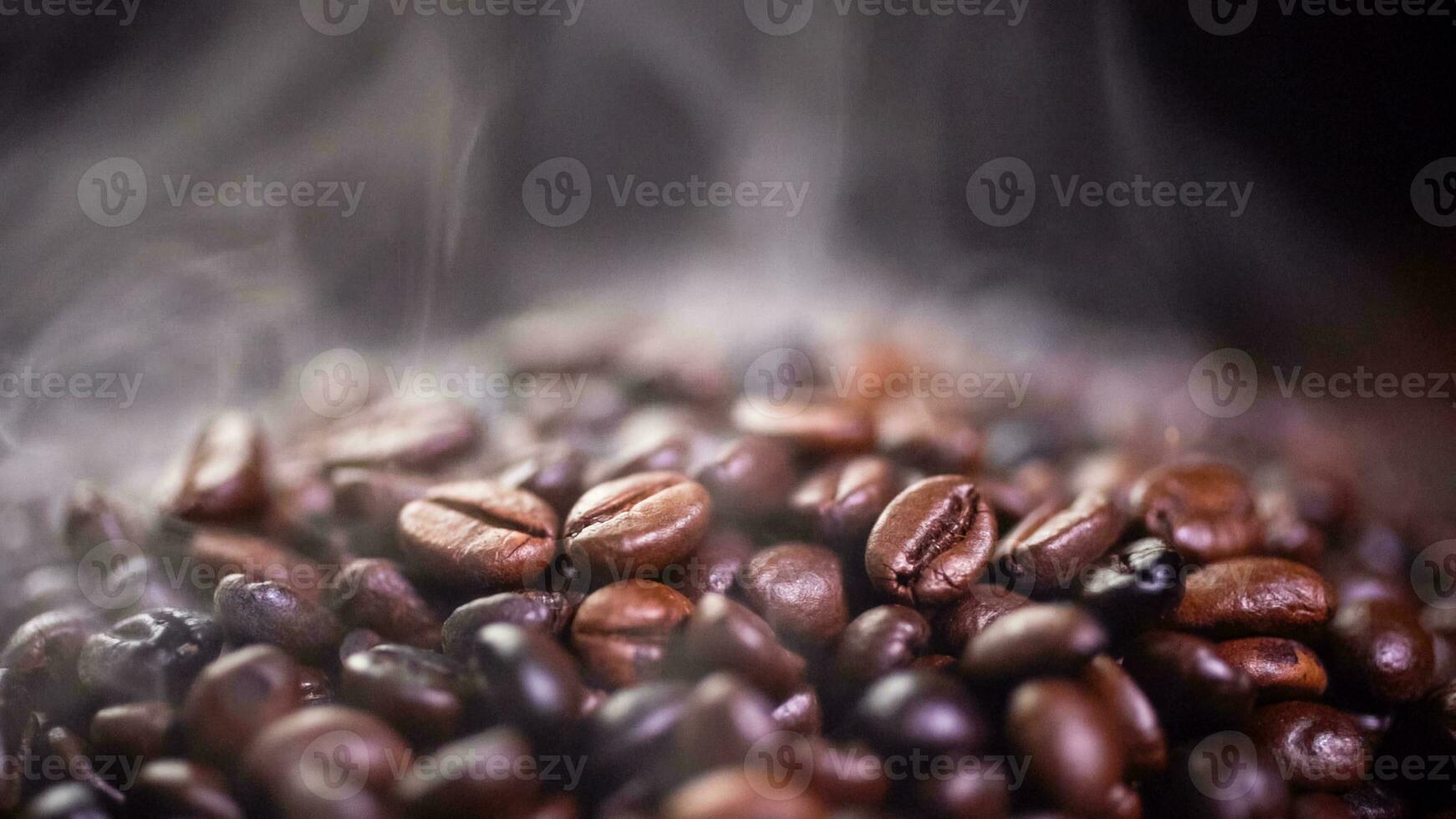 Coffee beans roasting with smoke,  selective focus, and soft focus. photo