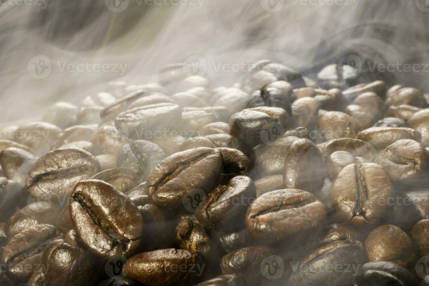 Coffee beans roasting with smoke,  selective focus, and soft focus. photo