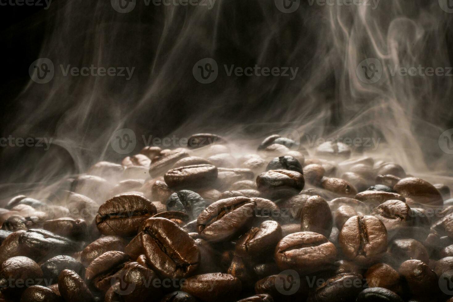Coffee beans roasting with smoke,  selective focus, and soft focus. photo