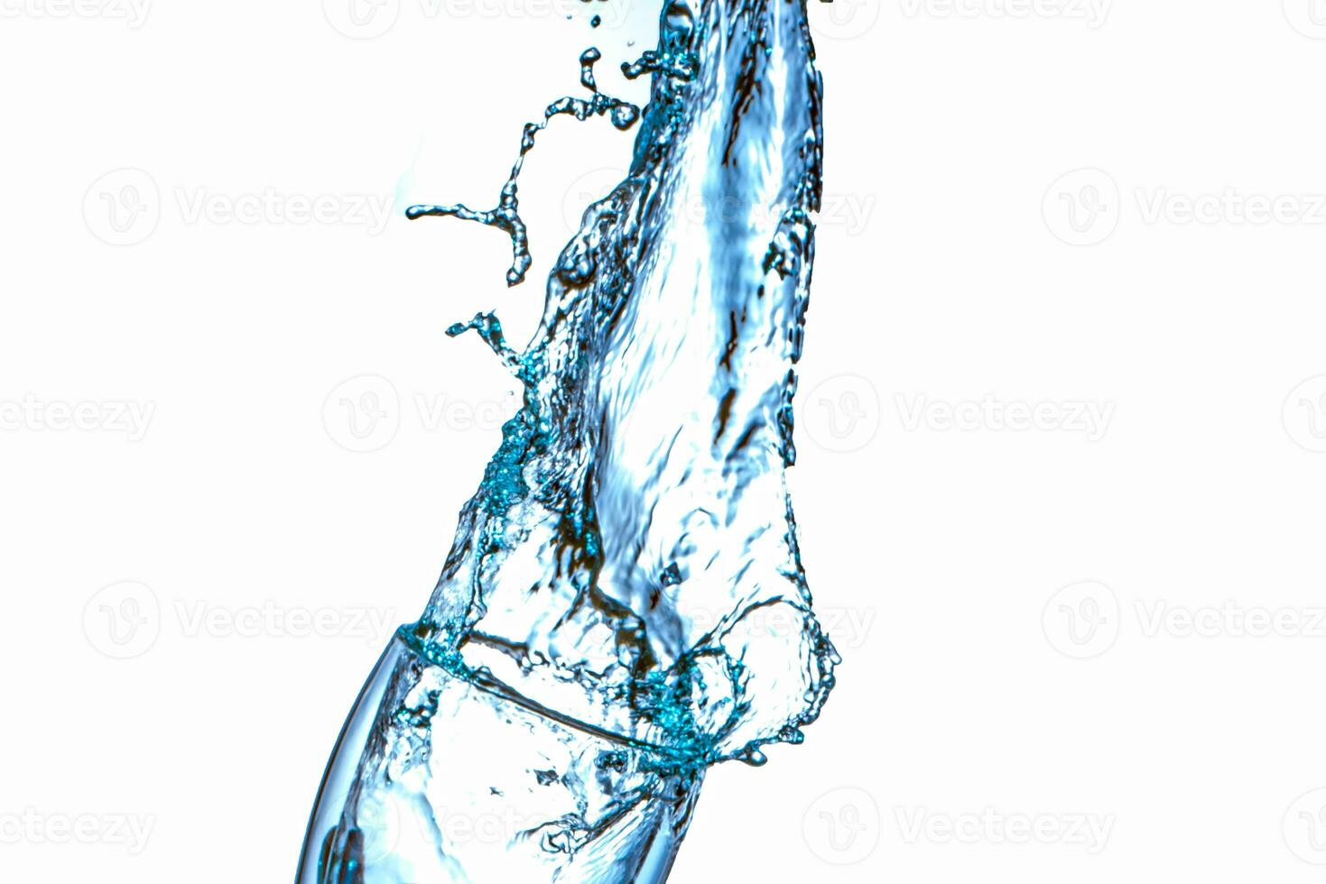 Drinking water splashing from the glass on white background photo