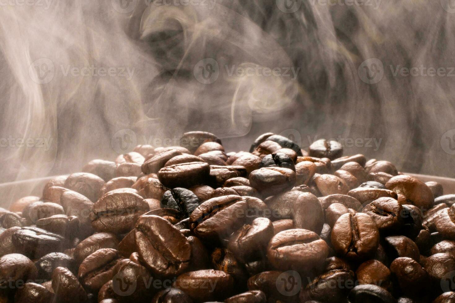 Coffee beans roasting with smoke,  selective focus, and soft focus. photo