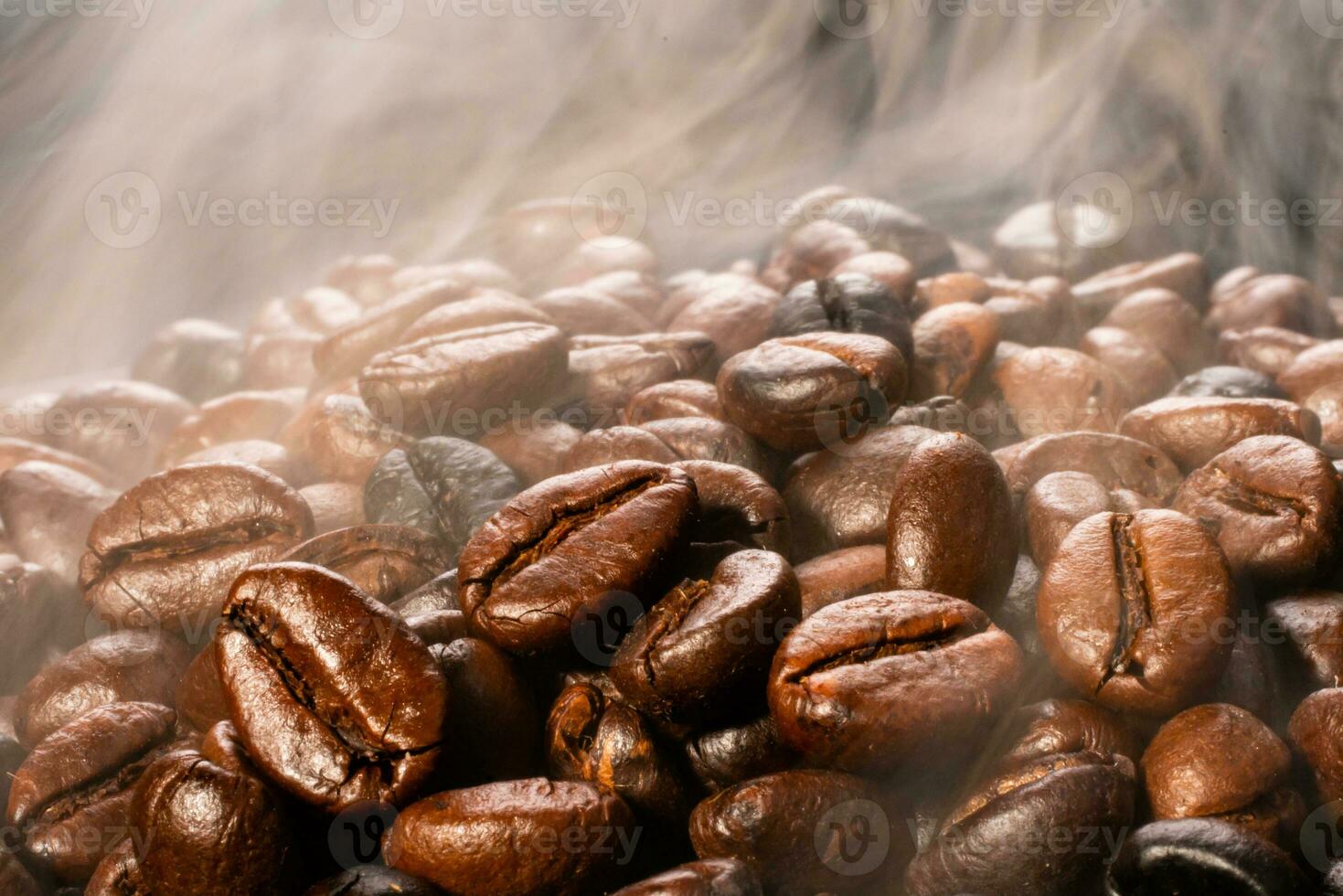 Coffee beans roasting with smoke,  selective focus, and soft focus. photo