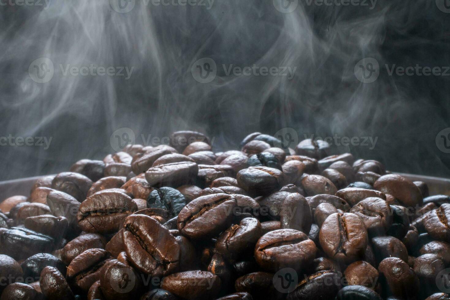 Coffee beans roasting with smoke,  selective focus, and soft focus. photo