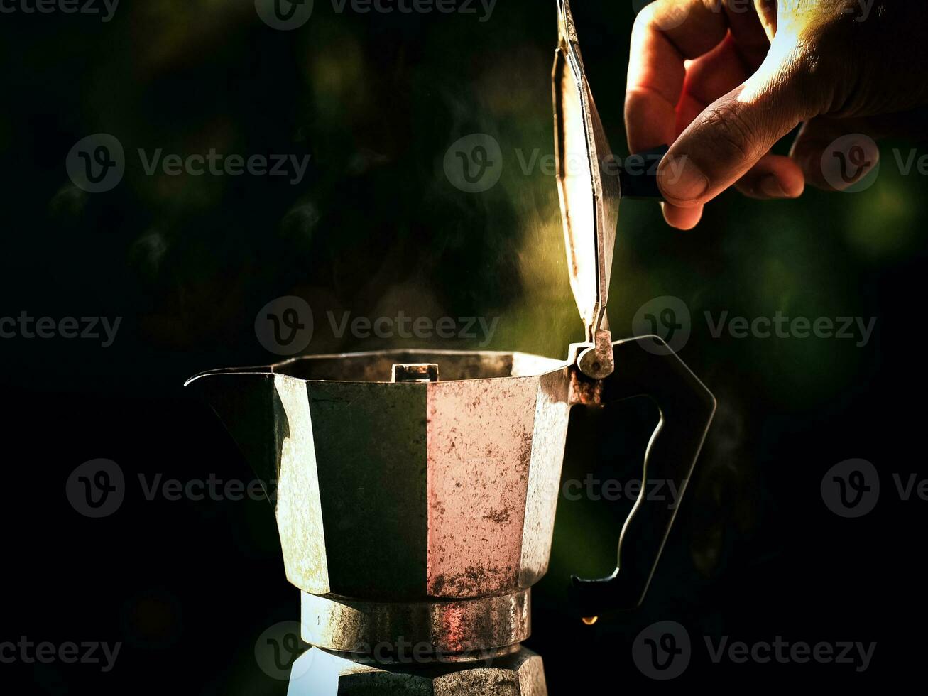 Moka pot coffee maker, making hot drinks in nature camp Traveling, relaxing outdoors, camping, lifestyle, morning picnic.selective focus, and soft focus. photo