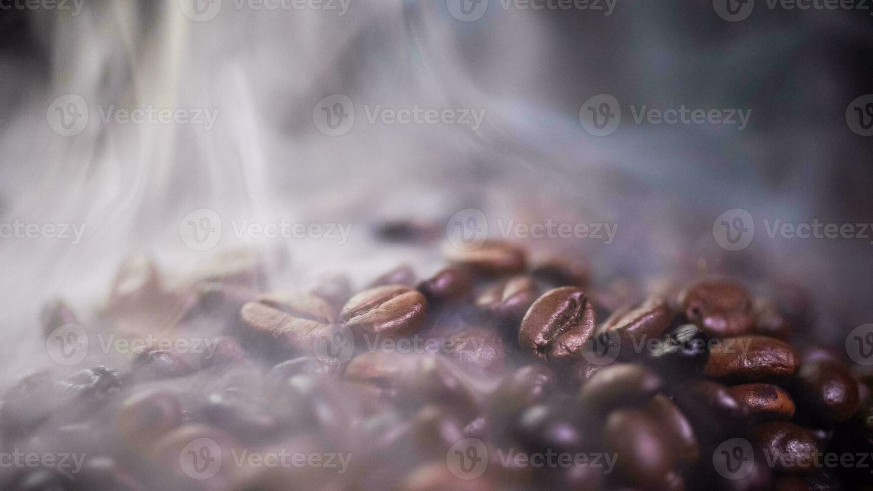 Coffee beans roasting with smoke,  selective focus, and soft focus. photo
