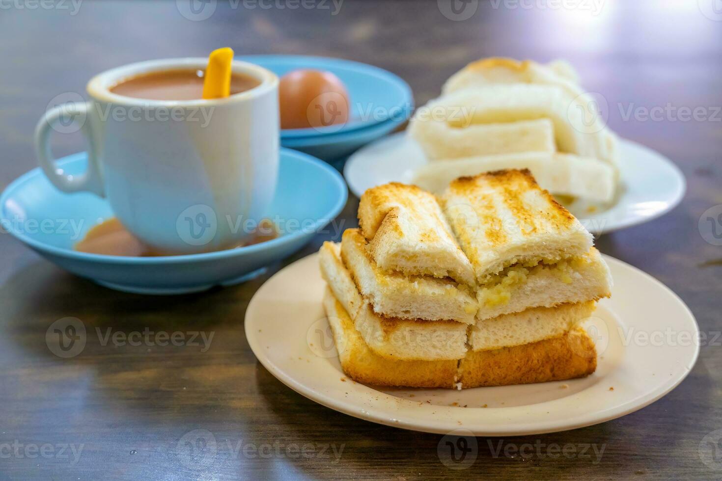 Traditional breakfast set and coffee, boiled eggs and toast, popular in Singapore photo