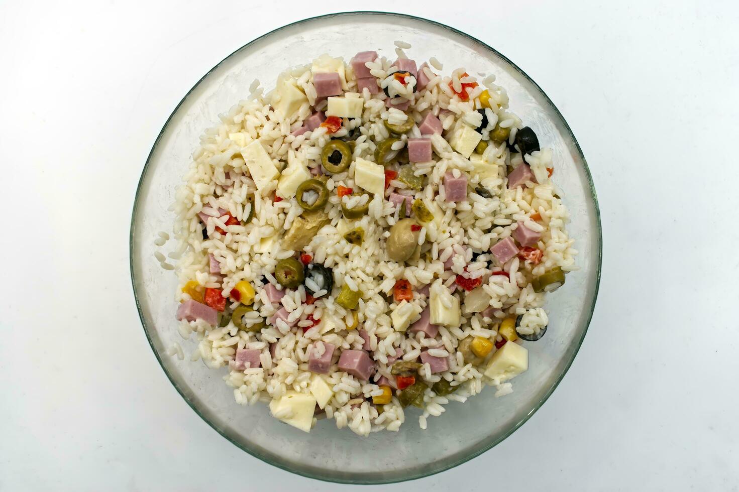 Cold summer rice salad isolated on white. Top view. photo