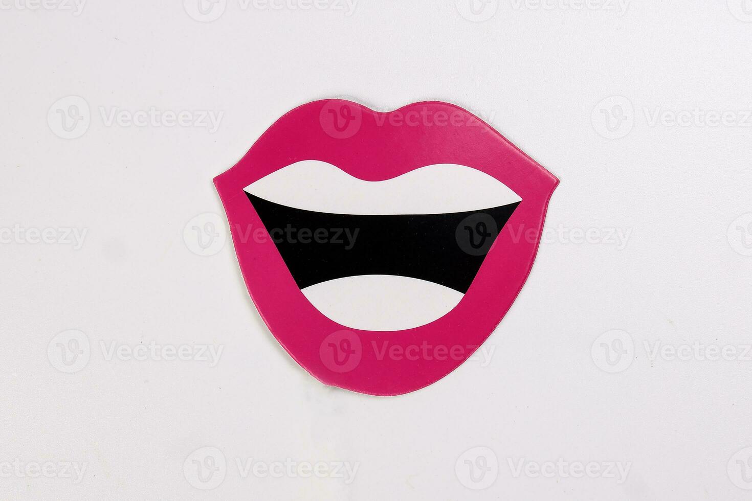 Red lips white teeth black open smiley mouth shape paper die cut selfie portrait party fun paper prop sticker stick on white background photo