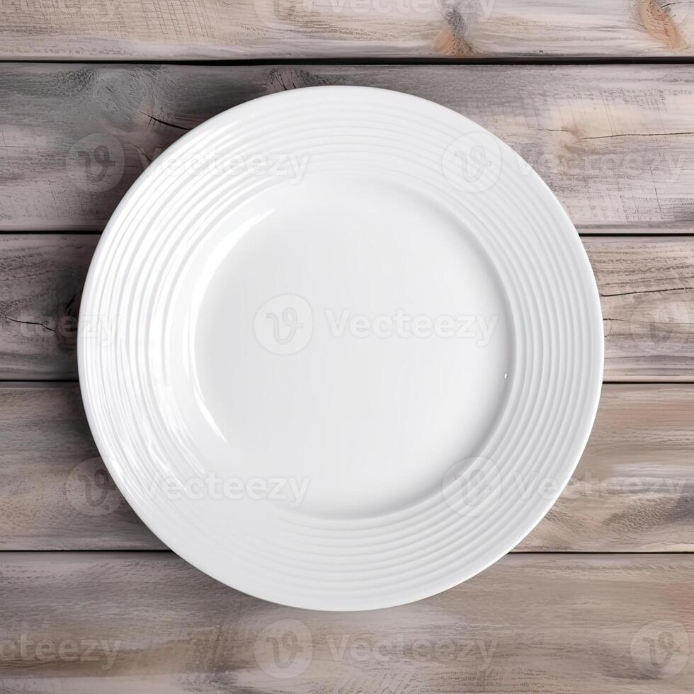 An empty plate on a white wooden table. Top view of white ceramic plate on white wooden. . photo