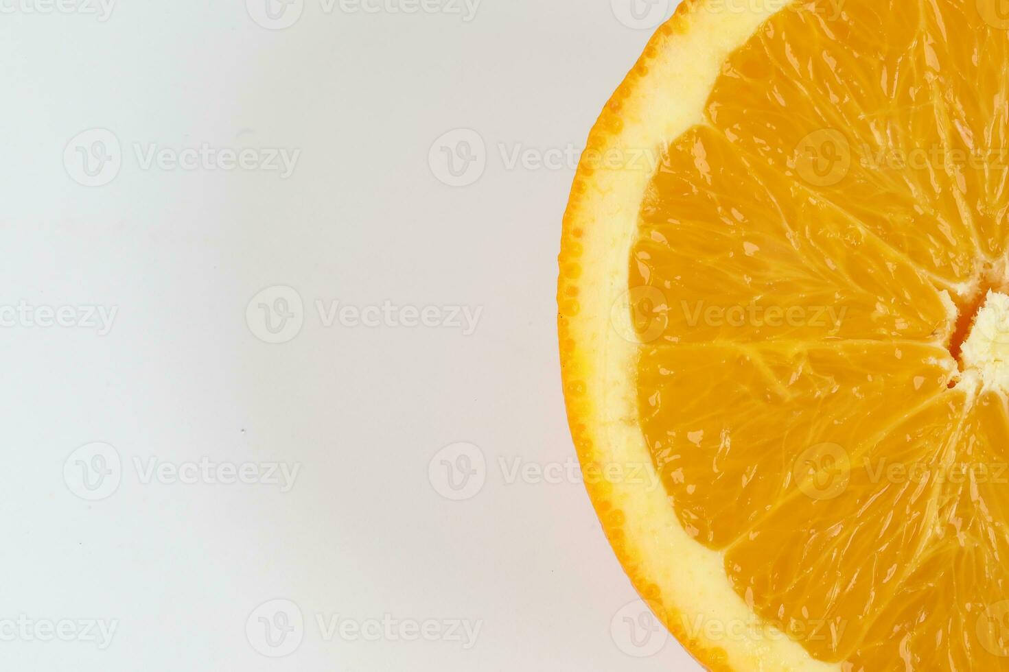 Ripe juicy orange half cut closeup on white background photo