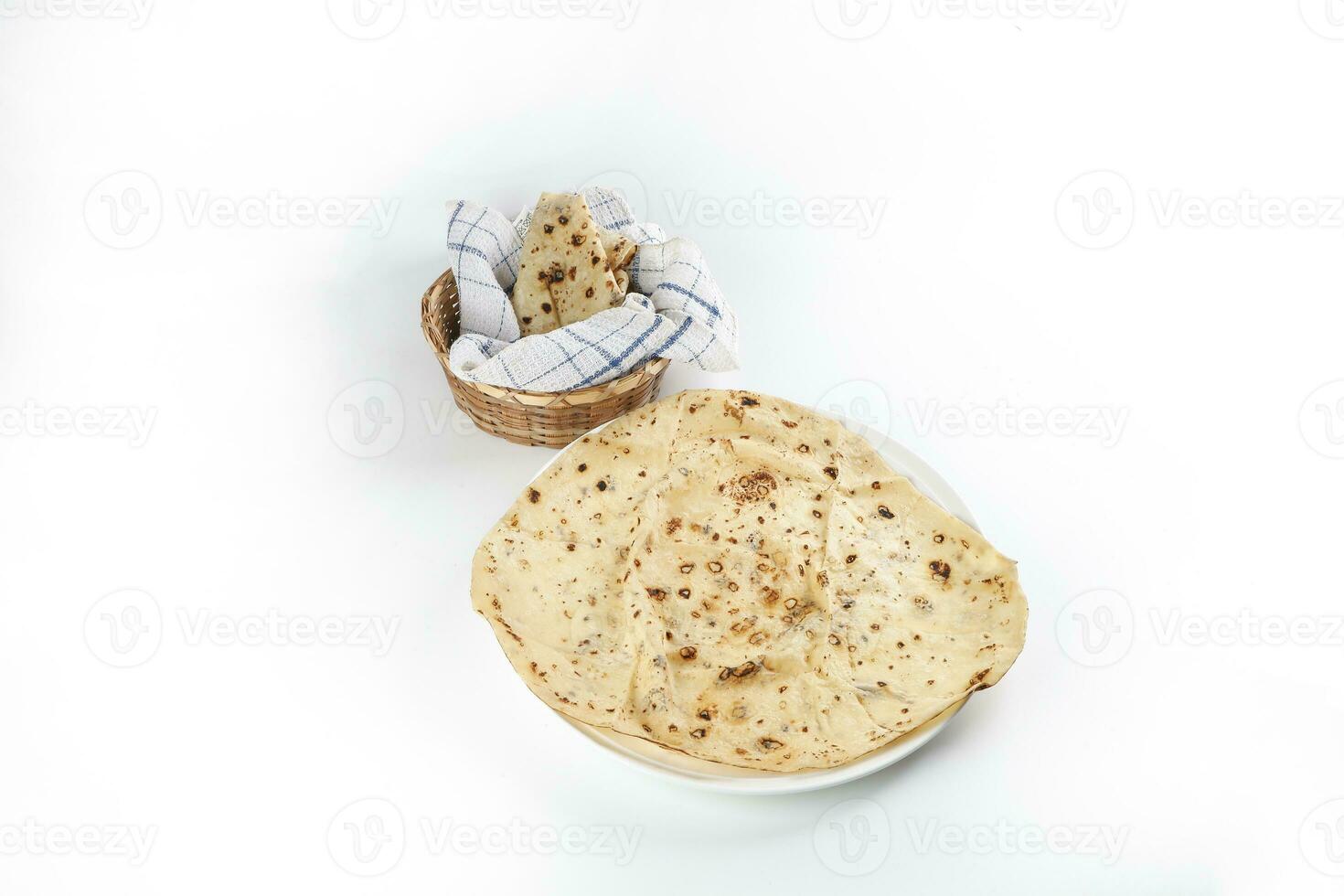 Paper thin rumali roit wheat chapati bread on white plate best served with dal tadka makhana photo