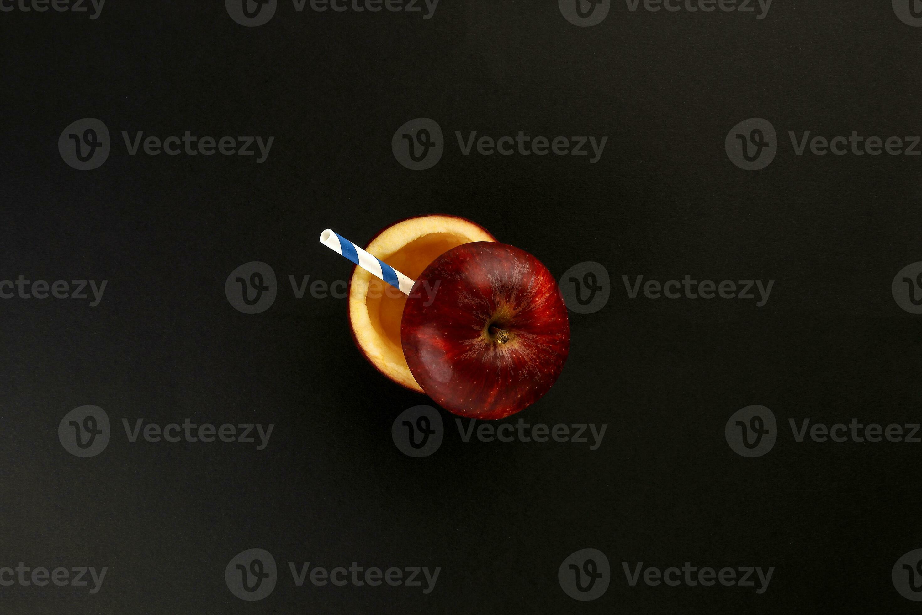 Health Red Cut Apple recyclable paper straw juice drink idea concept on black background
