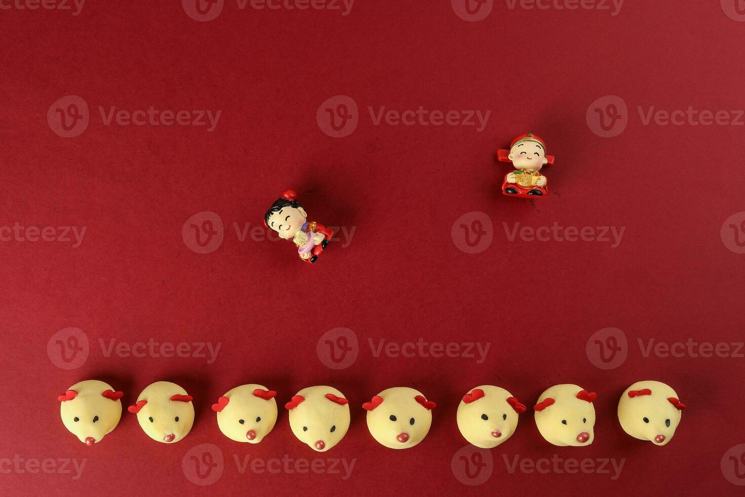 Chinese New Year rat mouse shaped cookie boy girl doll on red background photo