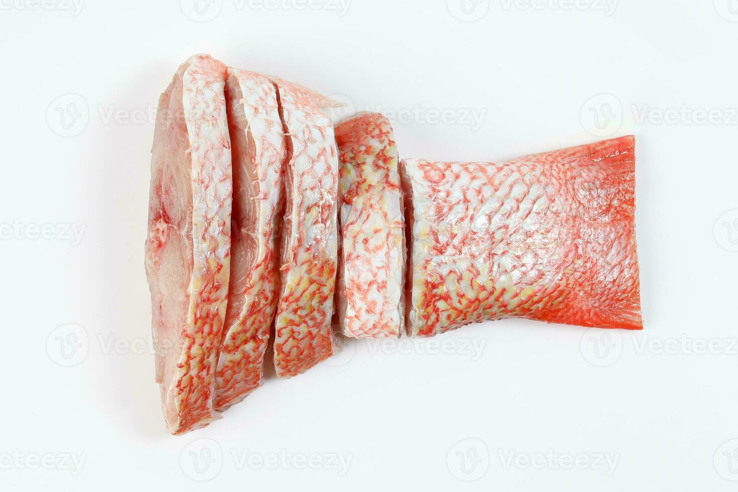 Cleaned descaled sliced red snapper fish fillet pieces on white background photo