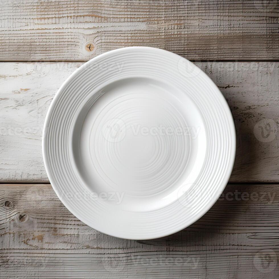 An empty plate on a white wooden table. Top view of white ceramic plate on white wooden. . photo