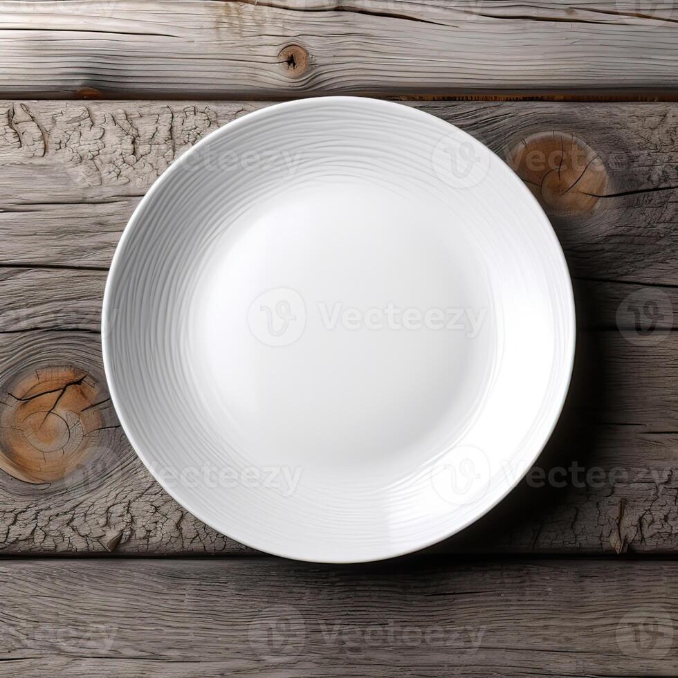 An empty plate on a white wooden table. Top view of white ceramic plate on white wooden. . photo