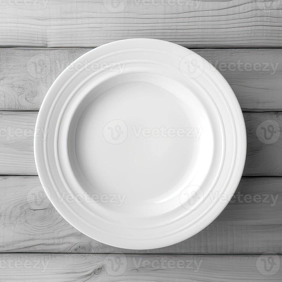 An empty plate on a white wooden table. Top view of white ceramic plate on white wooden. . photo