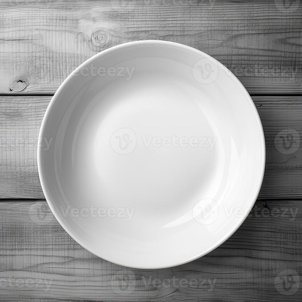 An empty plate on a white wooden table. Top view of white ceramic plate on white wooden. . photo