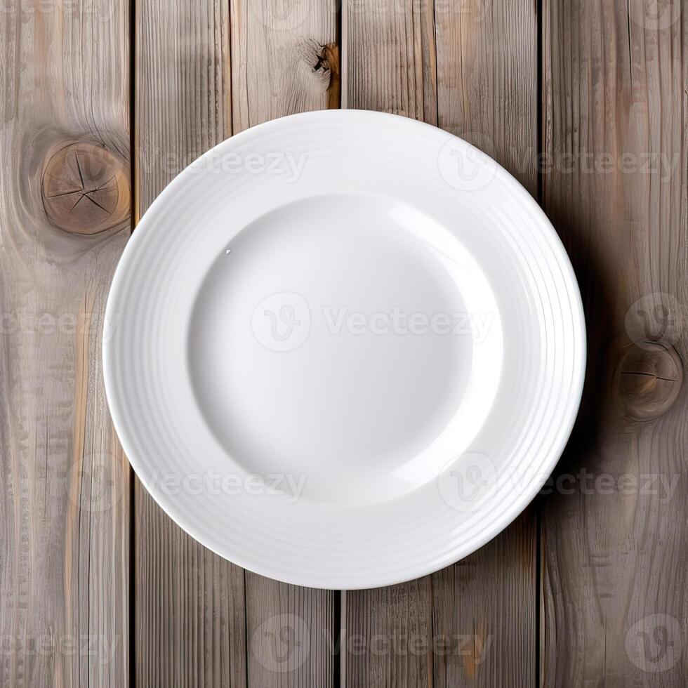 An empty plate on a white wooden table. Top view of white ceramic plate on white wooden. . photo