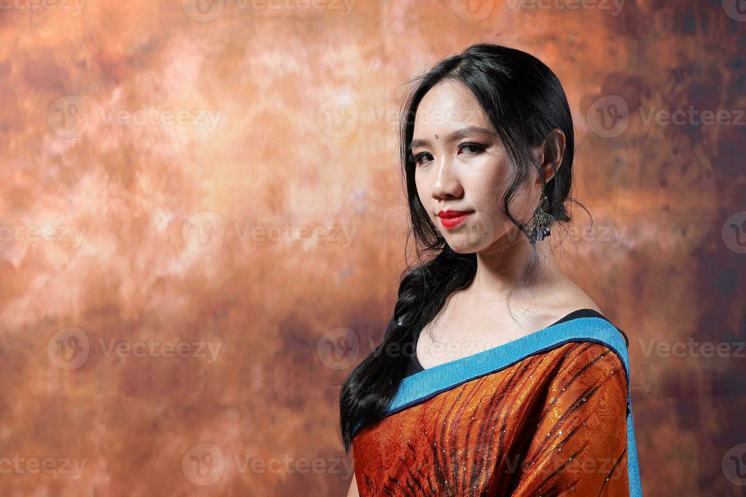 South east Asian Chinese race ethnic origin woman wearing Indian dress costume Sharee multiracial community on retro vintage background photo